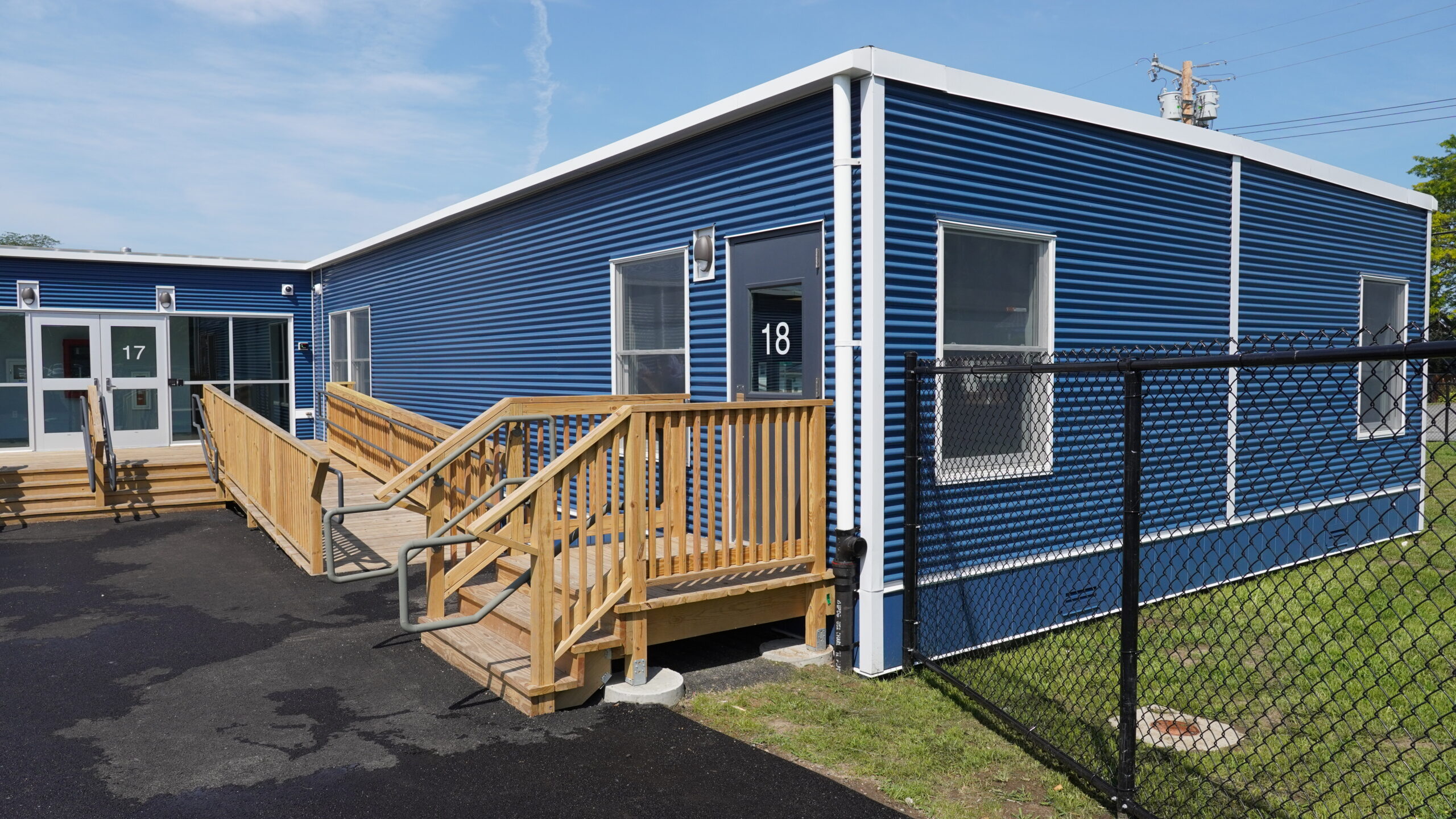 Classroom building exterior view with wooden stairway