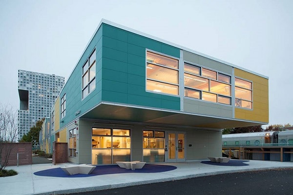 Modern triumph modular building showcasing a vibrant exterior and large windows, exemplifying modular construction design. Ideal for permanent or temporary modular building solutions.