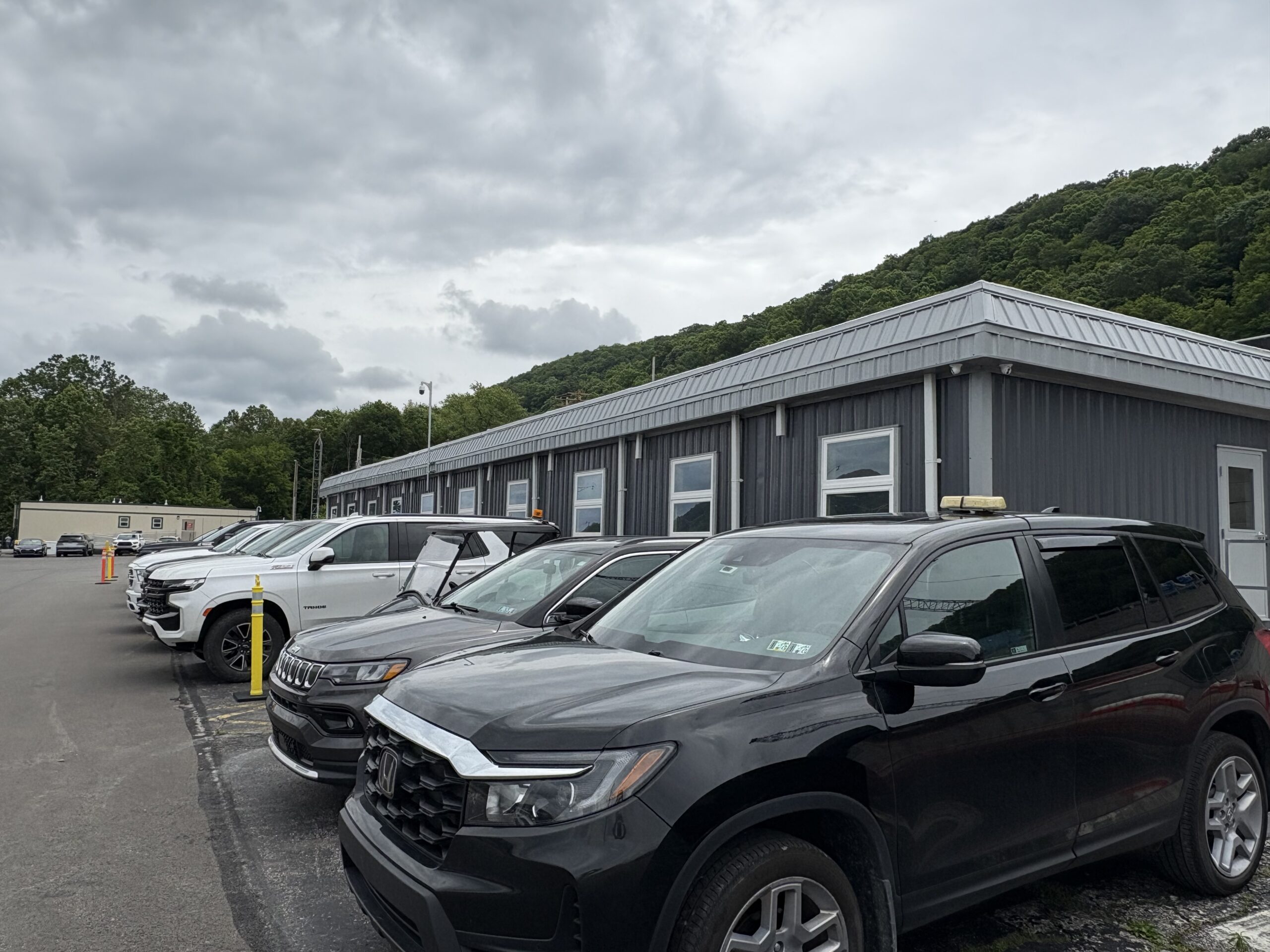 Exterior view of modular 10-piece building with cars parked in front