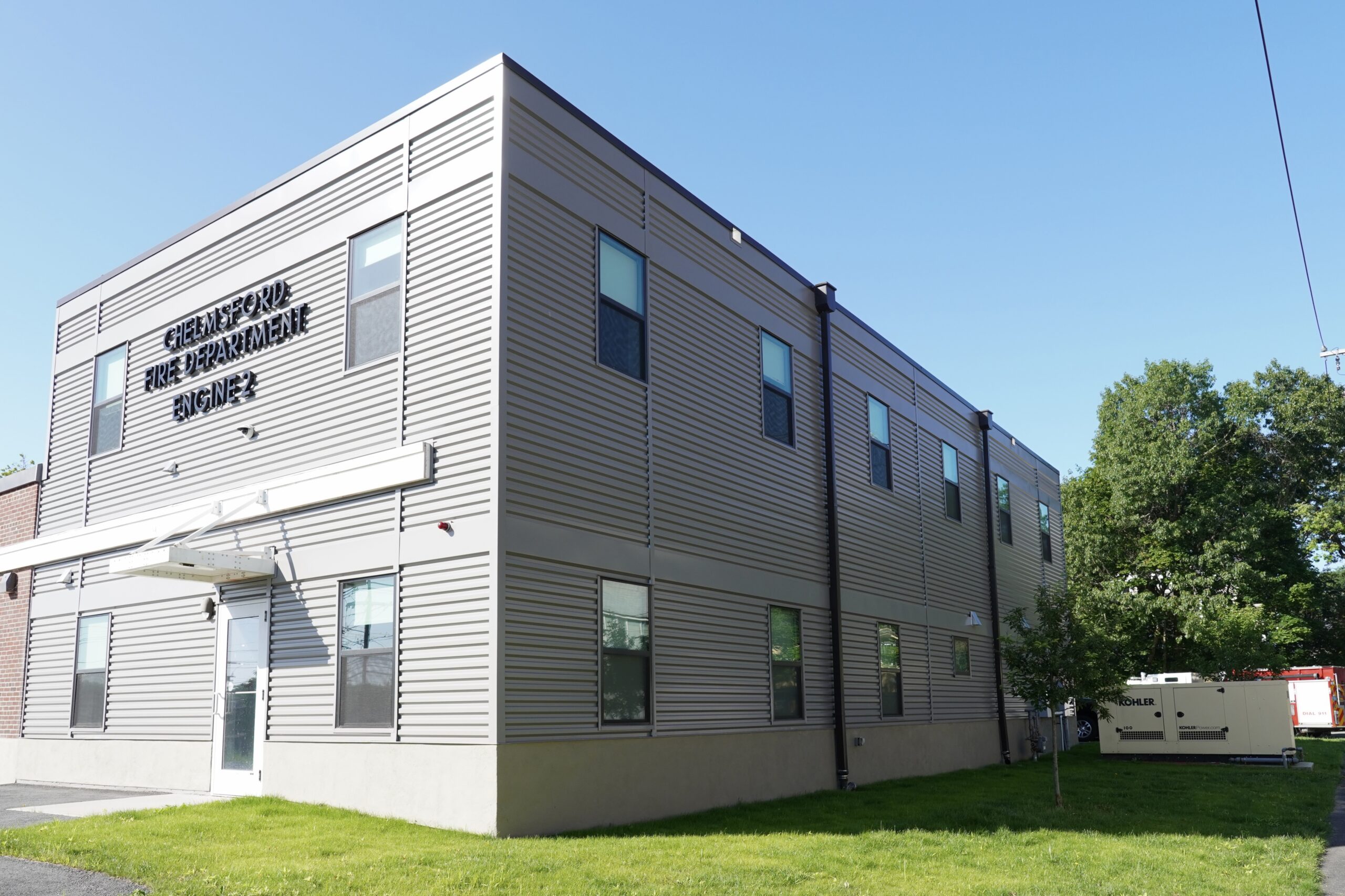 Exterior view of a two-story fire station with galvelume siding.