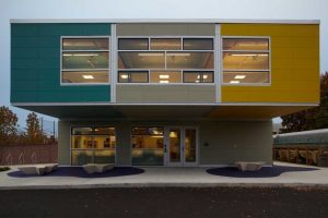 Modern triumph modular building showcasing vibrant colors and large windows, exemplifying modular construction techniques for permanent and temporary modular buildings.