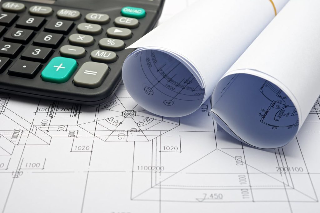 Architectural plan rolled up and calculator