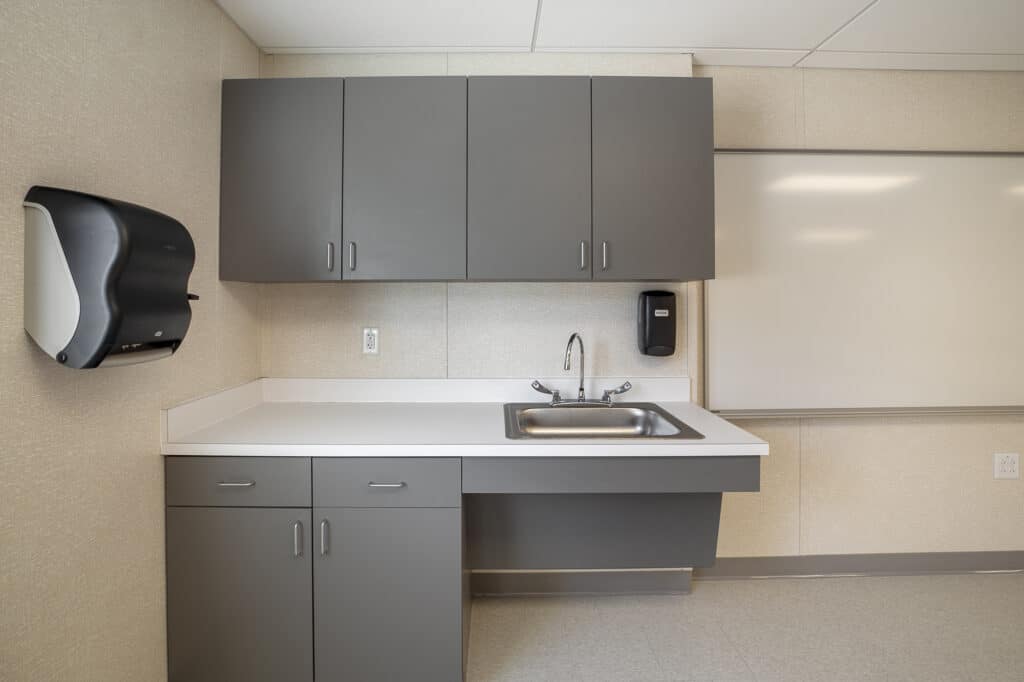Interior shot of a sink and cabinets inside a classroom space