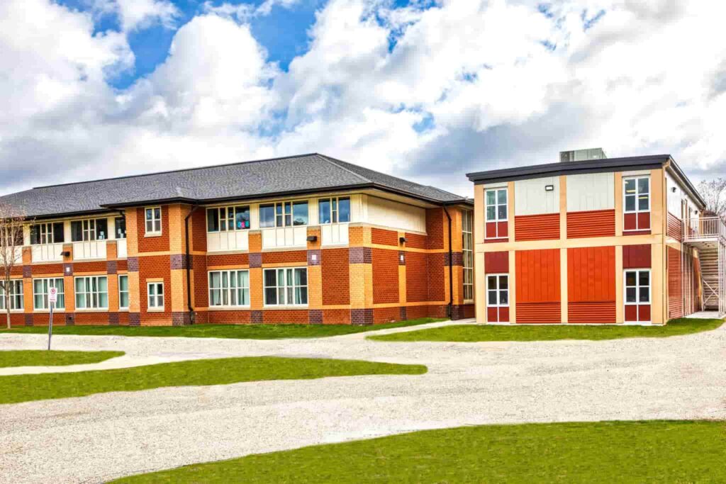Temporary modular school building with connected classroom units and ADA-compliant ramp