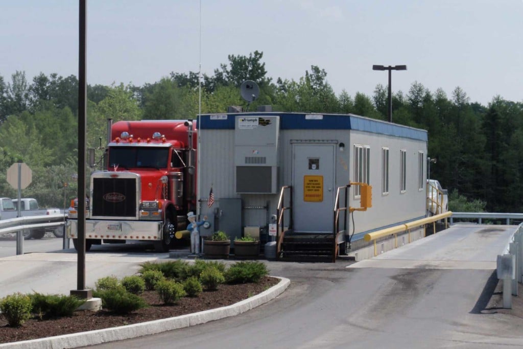 A red truck parked next to a permanent modular building, showcasing triumph modular construction.