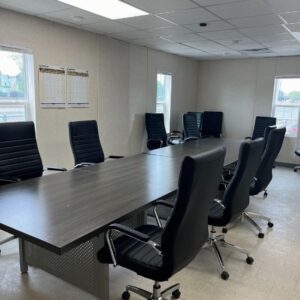 Conference room complete with Business Conference solution that includes a large conference table and eight chairs