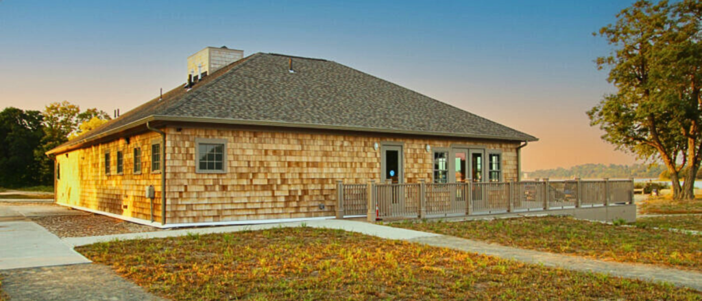 Side view of Hingham Community Space and Bath House at sunset.